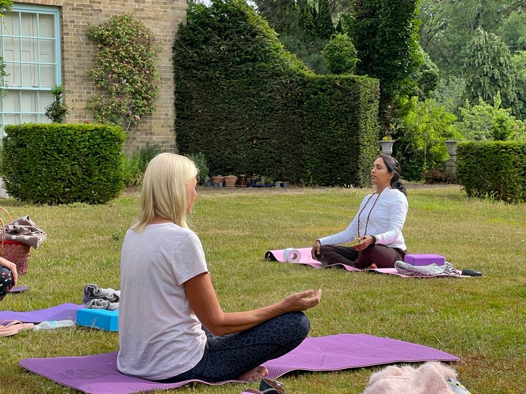 Praji leading outdoor meditation class